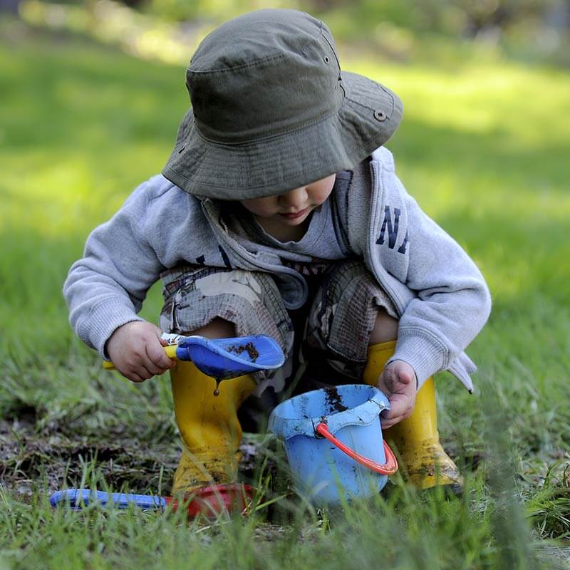 boy playing in the mud